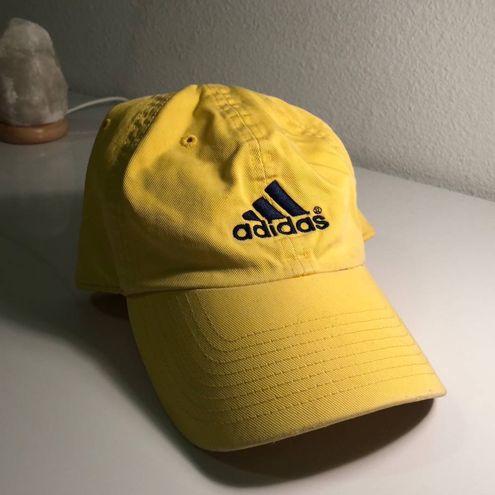Yellow adidas original cap with navy embroidery.